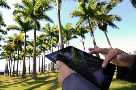 Image of man holding iPad outdoors in Brazil